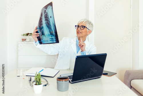 Shot of a maturee doctor analyzing an x ray of a patient’s chest. Shot of a senior doctor reading the results of an x ray in her consulting room. Healthcare, radiology and medicine concept.