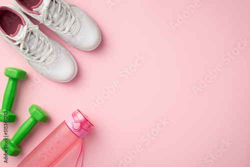 Fitness accessories concept. Top view photo of white sneakers pink bottle and green dumbbells on isolated pastel pink background with copyspace
