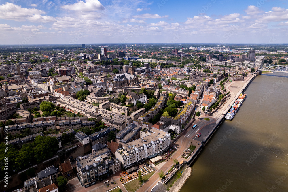 Aerial cityscape of Dutch Hanseatic town seen from above along the river Waal on a warm sunny day