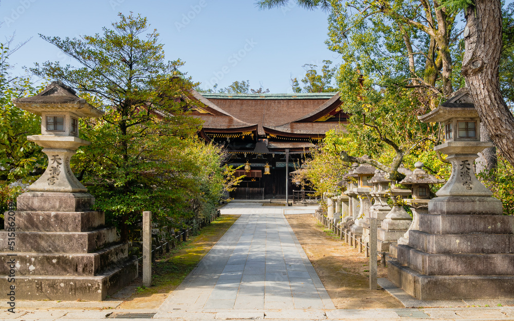 Avenue with stone lanterns at the entrance to Poet's Festival Kitano Tenmangu in Kyoto, Japan. Avenue with stone lanterns at the entrance to Poet's Festival Kitano Tenmangu in Kyoto, Japan.