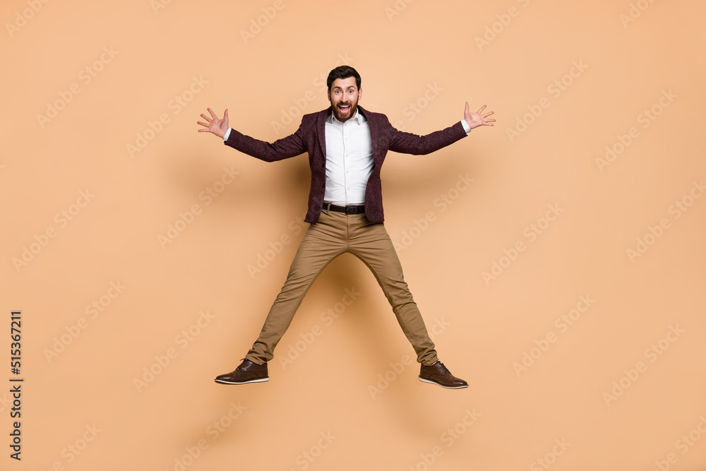 Full body photo of flying businessman have fun fooling around wear neat jacket isolated on beige color background Full body photo of flying businessman have fun fooling around wear neat jacket isolated on beige color background