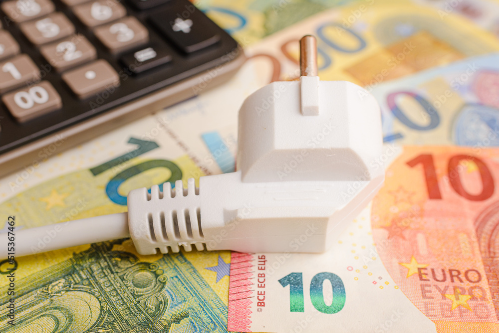 Electric Plug,euro banknotes,calculator flat laying on the table.The  concept of rising electricity prices.Top view. Stock Photo | Adobe Stock