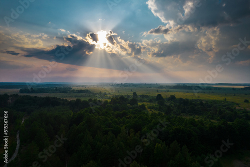 sunset in the clouds with the rays of the sun, view from the drone