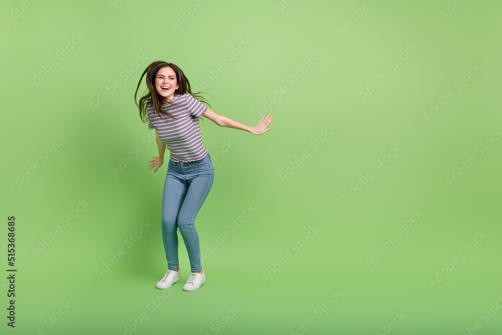Full length body size view of attractive cheerful girl dancing clubbing copy space isolated over bright green color background
