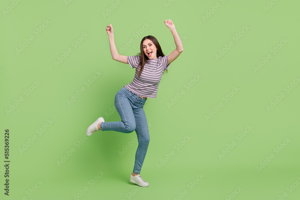 Full length body size view of attractive cheerful funny lucky girl dancing fooling isolated over bright green color background Full length body size view of attractive cheerful funny lucky girl dancing fooling isolated over bright green color background