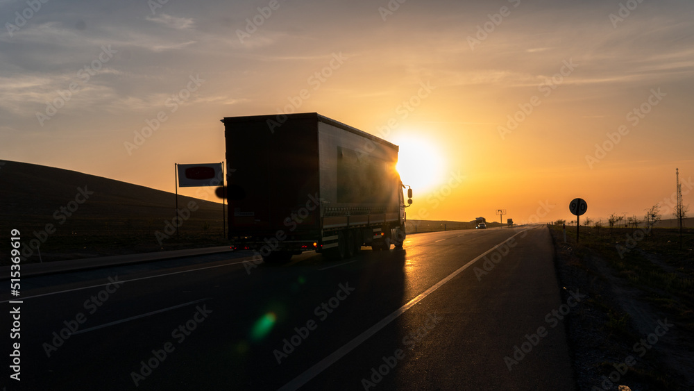 Vehicles exporting at sunrise 