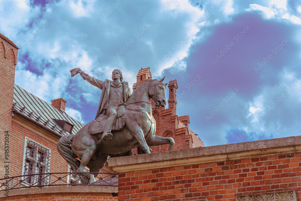 Fototapeta premium Close-up of an equestrian statue with a rider against a blue sky on a sunny day at the western entrance to the Wawel Royal Castle in Krakow, a gift to Poland on behalf of the people of Dresden