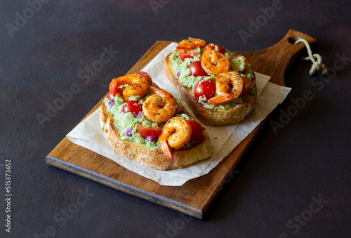 Bruschetta with shrimp, guacamole and tomatoes. Healthy eating. Breakfast.