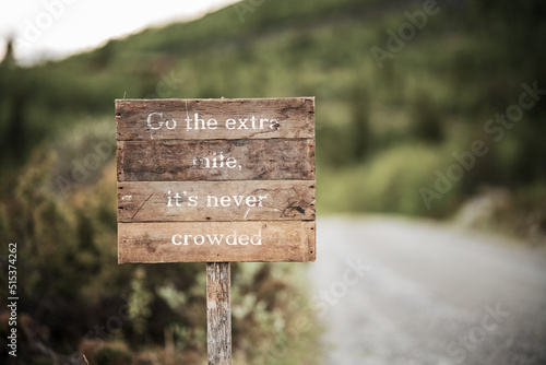 go the extra mile its never crowded roadsign photo