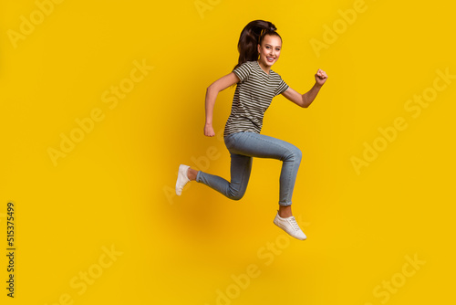 Fototapeta Naklejka Na Ścianę i Meble -  Full length body size photo of jumping high female student overjoyed run isolated on bright shine color background