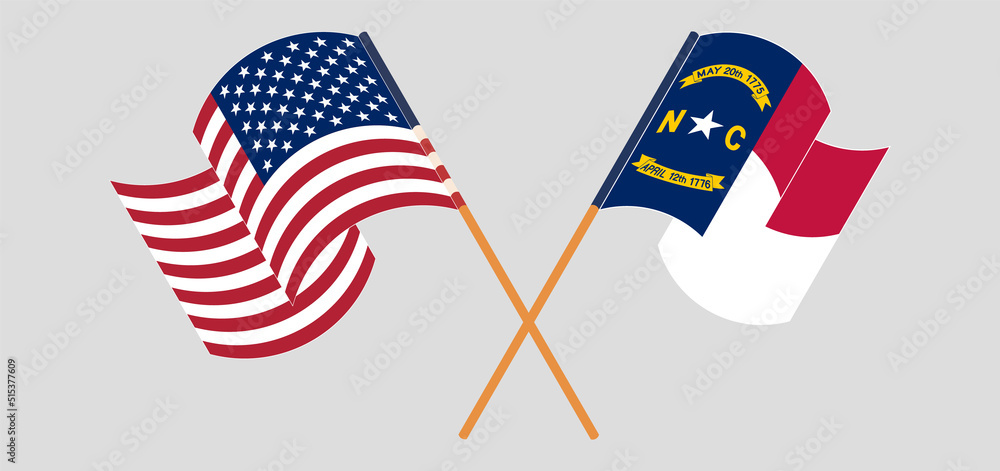 Crossed and waving flags of the USA and The State of North Carolina Crossed and waving flags of the USA and The State of North Carolina