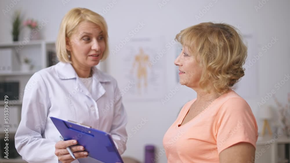 Physiatrist making good prognosis for happy female patient, successful treatment Physiatrist making good prognosis for happy female patient, successful treatment