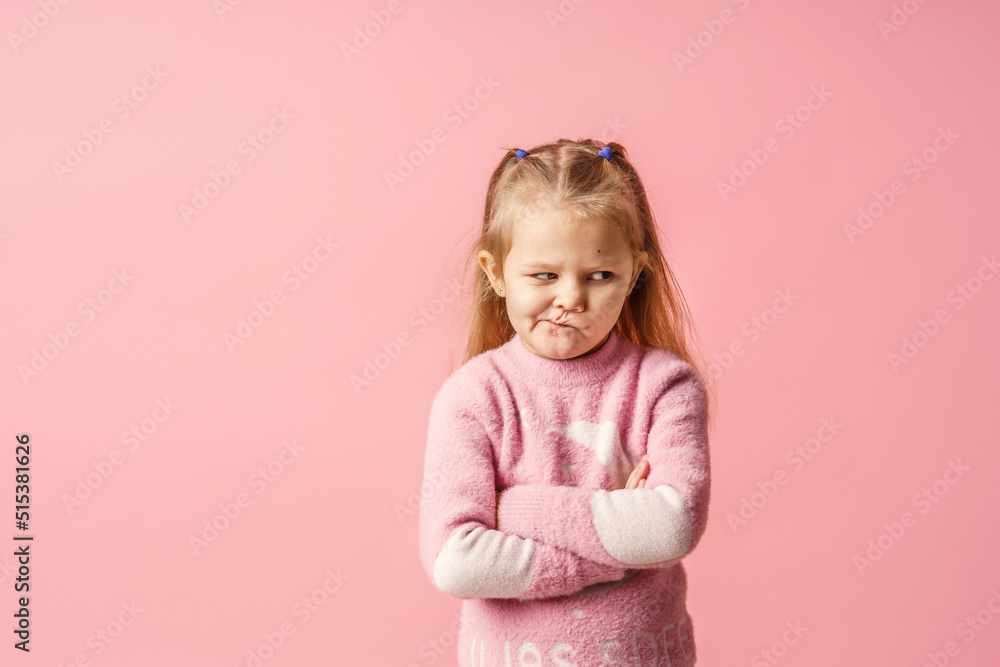 cute little Caucasian girl of 5 years old, insulted and offended on a pink background. The baby is tired, capricious and turns away. Does not make contact. Close-up cute little Caucasian girl of 5 years old, insulted and offended on a pink background. The baby is tired, capricious and turns away. Does not make contact. Close-up