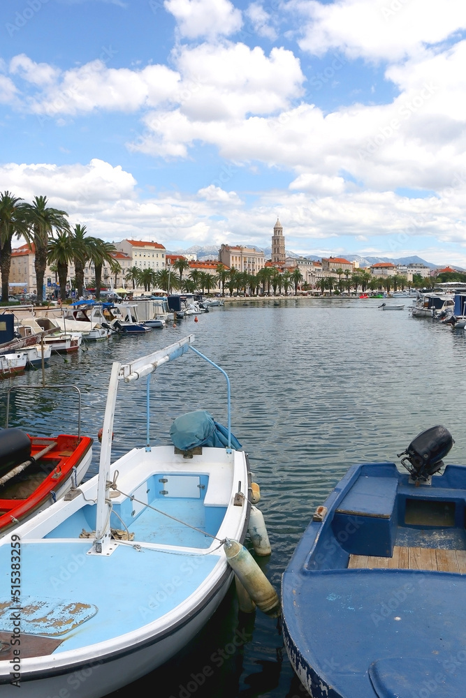 Promenade in Split, Croatia with landmark architecture and sailing boats.
