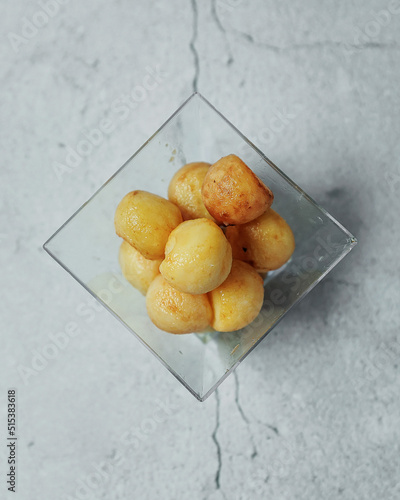 Appetizer of potatoes. French fries in a plastic cup. A small children's portion of a snack of French fries on a gray background