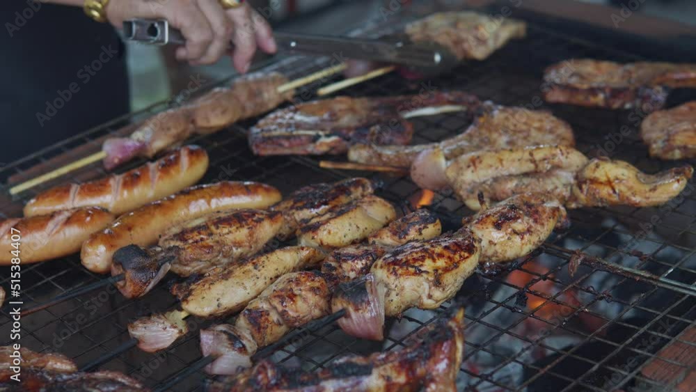 An aerial view of a unrecognizable man hands smoked pork meat on outdoor barbecue. Preparing dinner lunch eating summer food in backyard countryside An aerial view of a unrecognizable man hands smoked pork meat on outdoor barbecue. Preparing dinner lunch eating summer food in backyard countryside