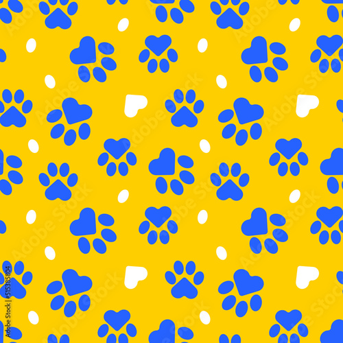 Paws of a cat, dog, puppy. Seamless cute pattern of animal footprints for textile. Blue and yellow colors. Vector.