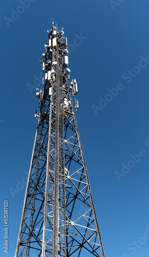 Cell phone relay tower. Metal mast. Metal structure with mounted relays. Steel structure against the sky.