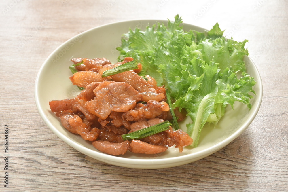 fried slice salty pork with lettuce on plate fried slice salty pork with lettuce on plate