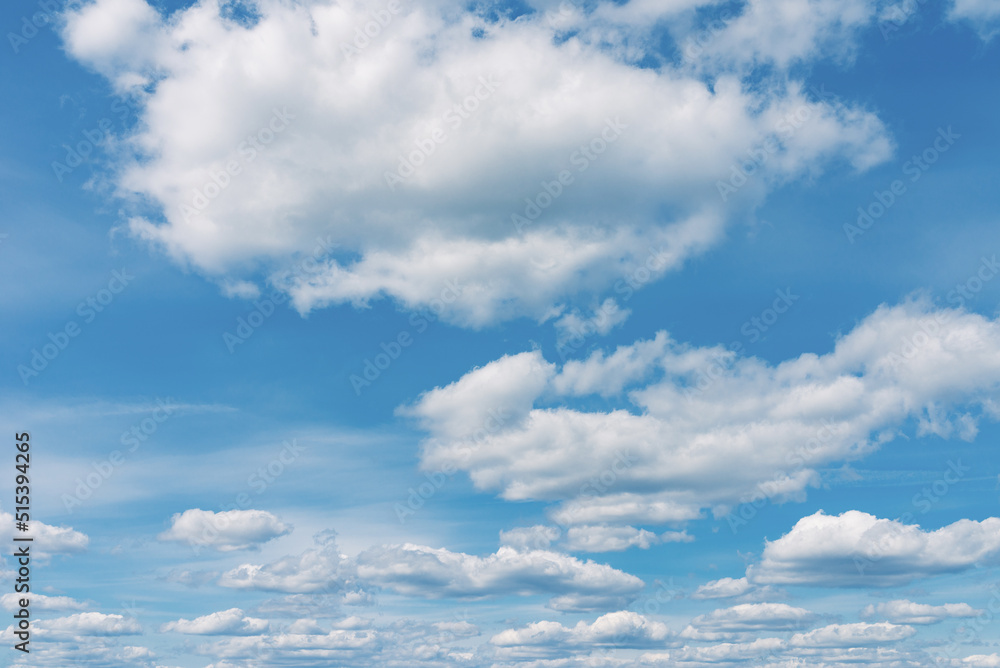 White clouds in the blue sky. White light cloudy heaven,good weather. Summer sky. Heaven and infinity. Curly clouds on a sunny day. Beautiful bright blue background. White clouds in the blue sky. White light cloudy heaven,good weather. Summer sky. Heaven and infinity. Curly clouds on a sunny day. Beautiful bright blue background.