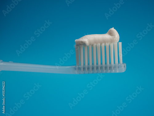 Toothbrush with copy space on blue background.