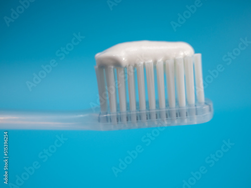 Toothbrush with copy space on blue background.