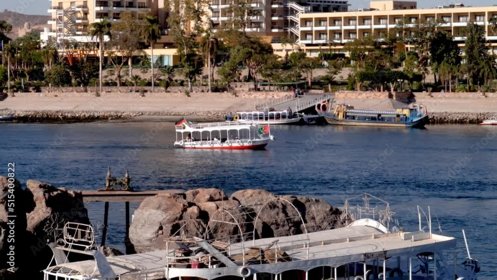 Traditional boat crusing through the Nile river with building in the ...