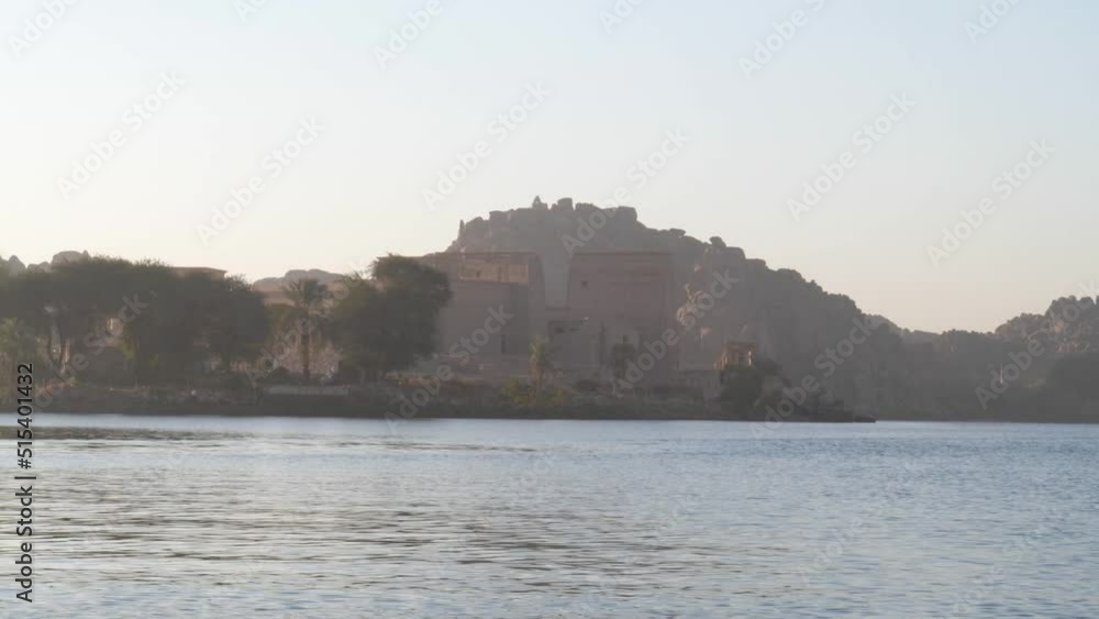 Temple of Philae from a boat during sunrise in Aswan, Egypt.