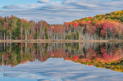 Autumn landscape of Council Lake with reflections of trees and clouds in calm water, Hiawatha National Forest, Michigan's Upper Peninsula, USA photo