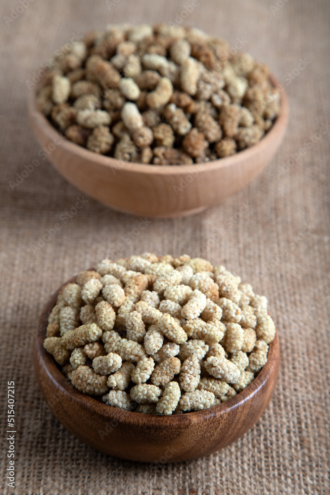Bowl full of dried mulberry on a fabric background Bowl full of dried mulberry on a fabric background