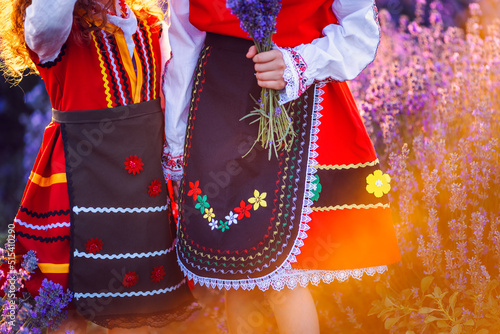 Photography Beautiful girls in traditional Bulgarian folklore costumes in lavender field dur