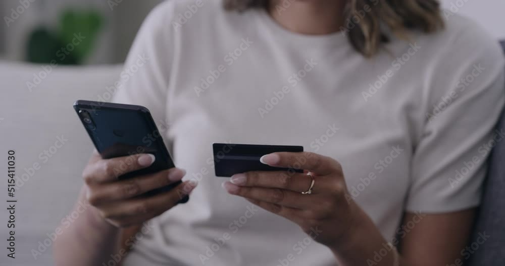 Womans hand using a phone and credit card and buying products electronically. Unknown female shopping online and paying bills digitally. Person doing internet banking conveniently from home Womans hand using a phone and credit card and buying products electronically. Unknown female shopping online and paying bills digitally. Person doing internet banking conveniently from home