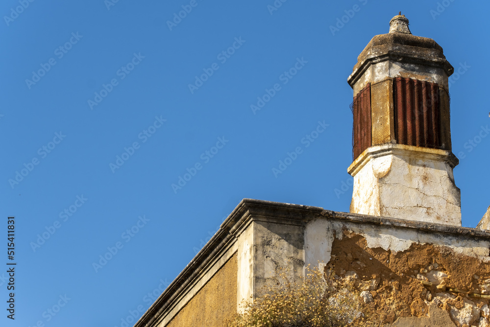 Close view of a traditional openwork chimney in Estoi, Faro district, Algarve, Portugal Close view of a traditional openwork chimney in Estoi, Faro district, Algarve, Portugal