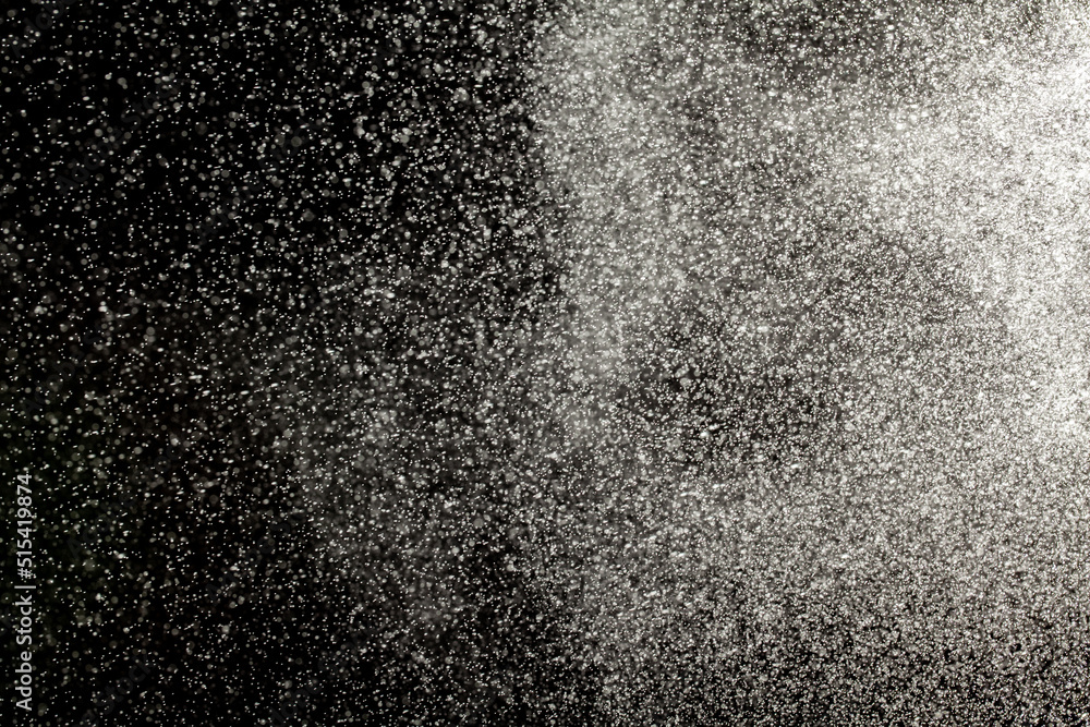 Sprayed water. Small droplets of water in the air. Lots of water drops, isolated on black background. Sprayed water. Small droplets of water in the air. Lots of water drops, isolated on black background.