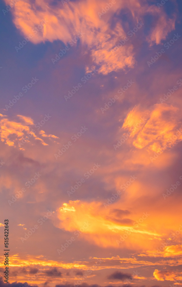 blue sky with lilac, yellow and orange with clouds underneath