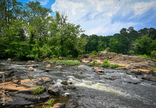 A beautiful landscape of bubbly whitewater rapids on the Haw River in the forest in North Carolina during summer in HDR.