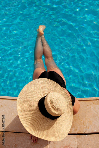 Beautiful woman sunbathing by the pool top view horizontal. Summer background. Poster, mock up for design photo