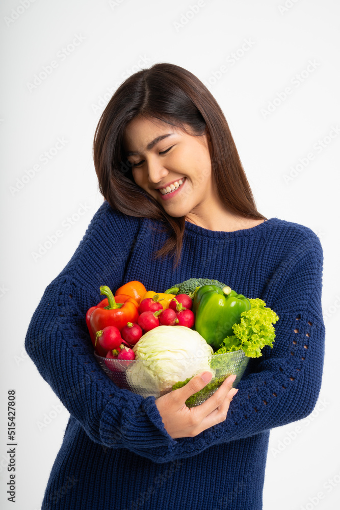 Portrait of beautiful smiling asian woman holding bowl full of fresh organic vegetables isolated on white background, concept of healthy food nutrition, Concept of healthy food nutrition, vegetarian Portrait of beautiful smiling asian woman holding bowl full of fresh organic vegetables isolated on white background, concept of healthy food nutrition, Concept of healthy food nutrition, vegetarian