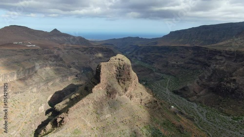 aerial shot in orbit of the mountain located near the Ansite Fortress on the island of Gran Canaria. Ancient Aboriginal caves are found inside. photo