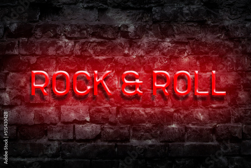 Rock and Roll.Red Neon sign on an old brick wall. Music. Style in Music. Music background.