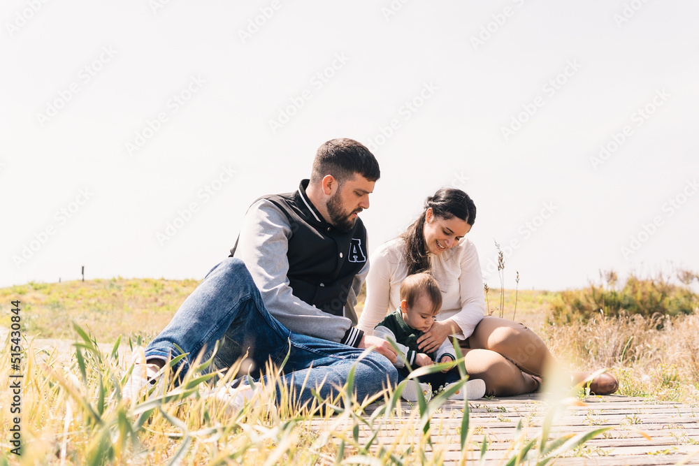 Parents playing with their son on the beach. Family concept. Parents playing with their son on the beach. Family concept.