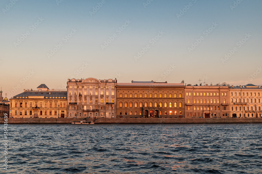 Sunset on the Neva river. View of the Palace embankment.
