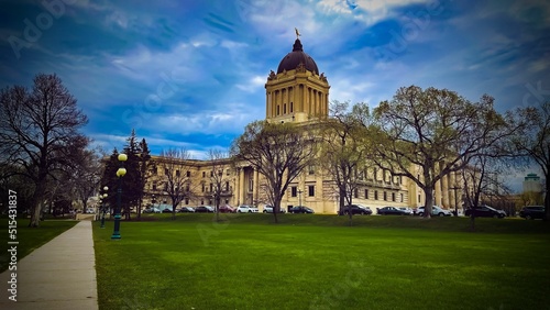 Beautiful Manitoba Legislative building with a green park and cars in front in Winnipeg, Canada photo