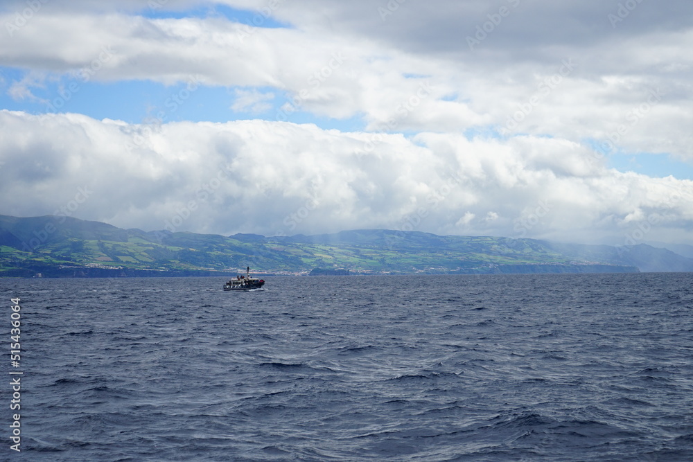 Fototapeta premium Boat sailing over Sao Miguel island, Azores, Portugal