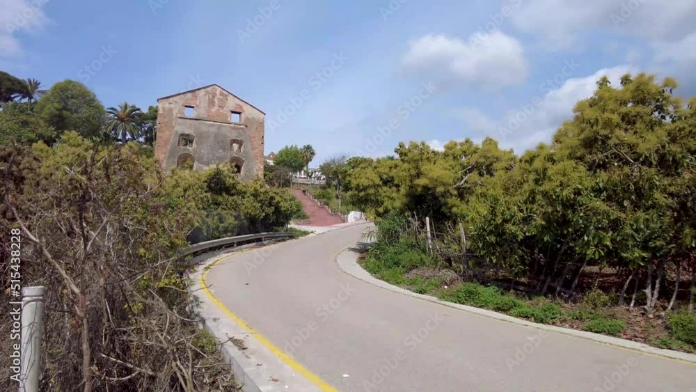 The curved road outside the ruin of the sugarcane factory in Maro. An abandoned factory in a small village outside Nerja in Spain. Farmland outside the town in Spain. A pole on the side of the road. The curved road outside the ruin of the sugarcane factory in Maro. An abandoned factory in a small village outside Nerja in Spain. Farmland outside the town in Spain. A pole on the side of the road.