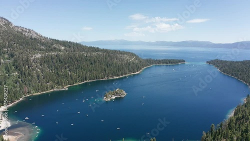 Wide panning aerial shot of Emerald Bay with boat traffic in Lake Tahoe. 4K photo