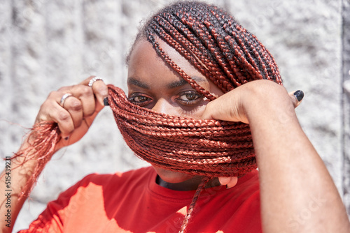 Canvas-taulu African American woman covering her face with red braided dreadlocks