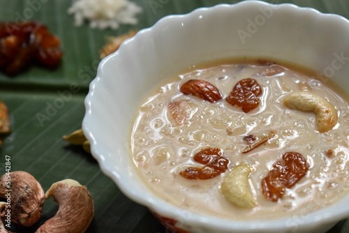 Closeup of a bowl of kheer pudding on green tile photo