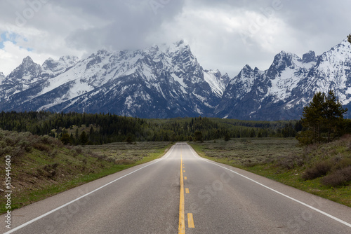 Scenic Road surrounded by Mountains and Trees in American Landscape. Spring Season. Grand Teton National Park. Wyoming, United States. Nature Background. © edb3_16