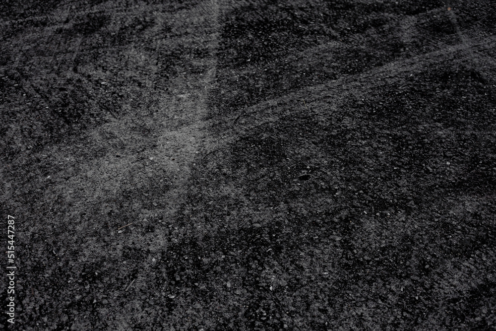 Abstract pattern background image. concrete surface. Modern black tones. Wheel marks on the floor. Abstract pattern background image. concrete surface. Modern black tones. Wheel marks on the floor.